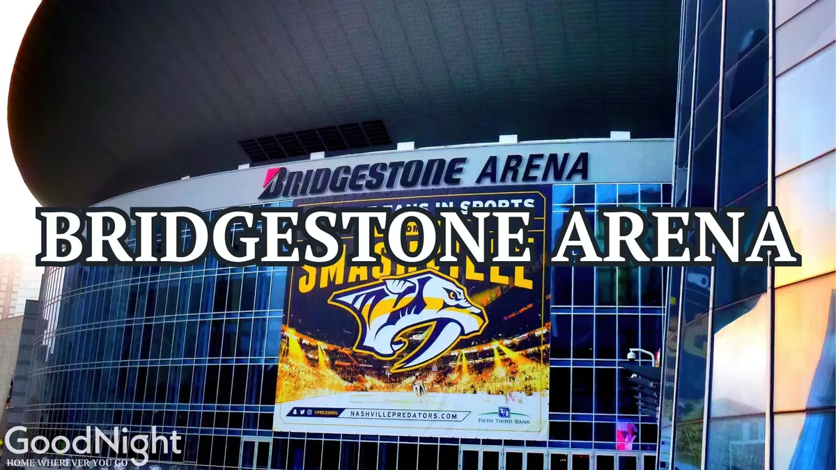 An exterior view of Bridgestone Arena, featuring the prominent arena sign, Predators banner, and modern architecture. The venue buzzes with the excitement of upcoming sports events, concerts, and large community gatherings.