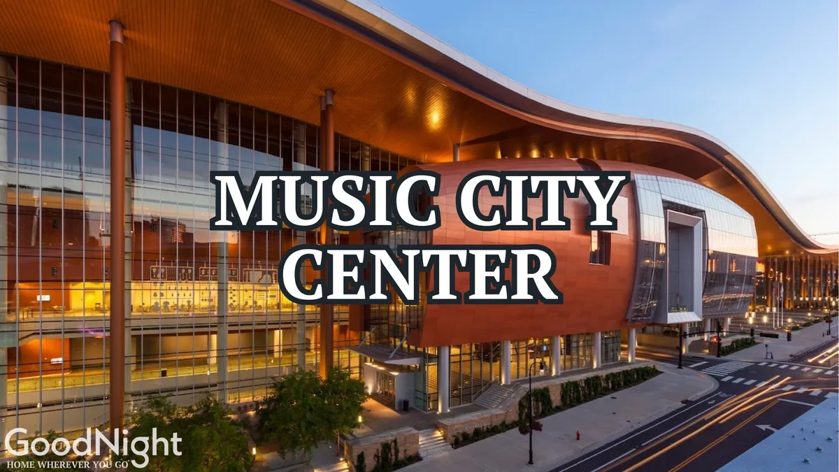 The image showcases the striking exterior of the Music City Center, with its modern curved roof, expansive glass windows, and a landscaped entrance bustling with activity. Visitors can be seen entering and exiting the venue, underscoring its role as a major business and event hub in downtown Nashville.